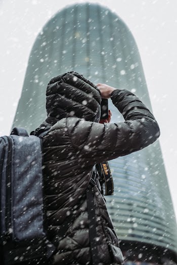 Person Wearing Winter Jacket While Snowing