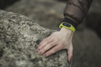 Person Wearing Yellow Fitness Band Holding Rock