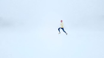 person wearing yellow jacket and black pants