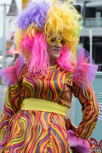 Person Wearing Yellow, Pink, and Purple Hair Witg