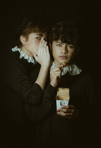 Person Whispering To Man's Ear
