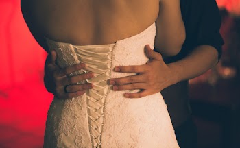 Person With Black Dress Shirt Holding Woman's Waist Close-up Photo