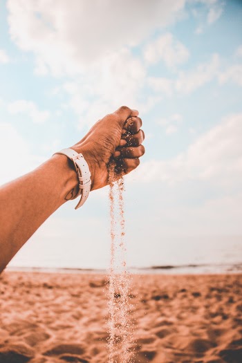 Person With Watch Grabbing Sand