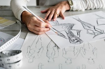 person writing a sketch art