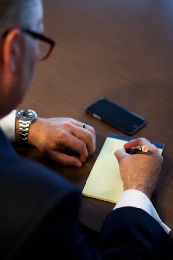 Person Writing Notes on White Ruled Paper