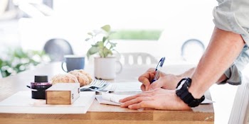 person writing on paper