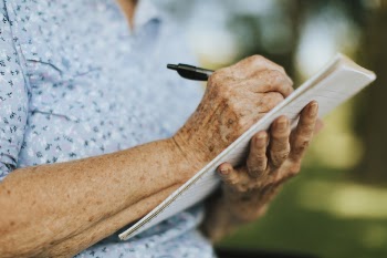 Person Writing on Paper