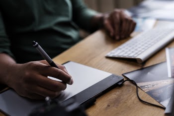 Person Writing on Tablet Computer