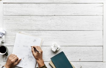 Person Writing on White Paper
