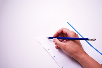 Person Writing On White Paper