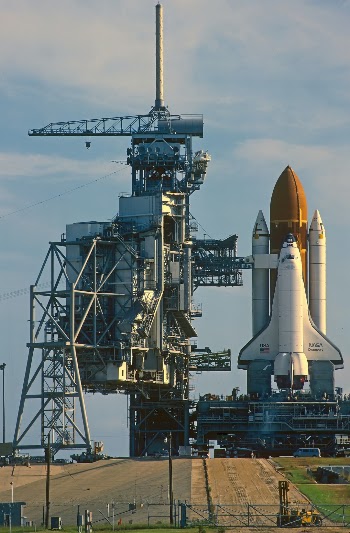 Personal one to one tour. August 1985.
Taken out to launch pad very early morning.
Preparing for Launch  STS-51 
During short window before the Service gantry is closed against the Shuttle “Discovery”. 
This is from a scan I did from a slide film I took,so quality not 100%.
Note…Most travelled shuttle, 149 million miles, 39 missions, 365 days in orbit over 27 years.
Now in the “Smithsonian Air and Space museum”