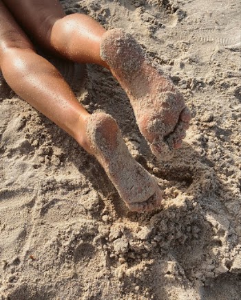 Persons Feet on Brown Sand