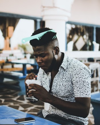 Photo Man Wearing White Button-up Collared Shirt With Hair Comb on the Hair Eating Ice Cream
