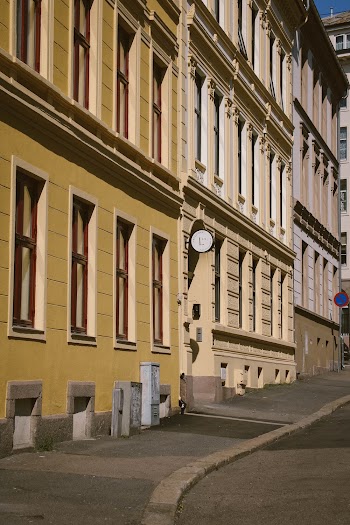Photo of a Block of Buildings Along Empty Sidewalk