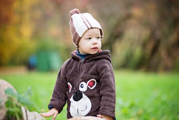Photo of a Boy Wearing Brown Jacket