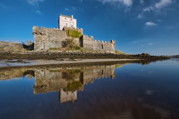 Photo of a Concrete Castle Beside Body of Water