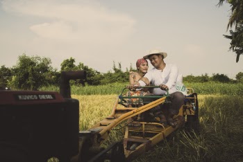 Photo of a Couple Riding on Tractor