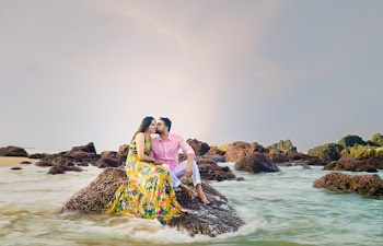Photo of a Couple Sitting on Rock