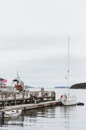 photo of a fishing vessel near on the concrete floor