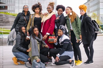 Photo of a Group of Women Near Buildings