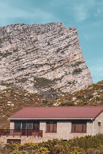 Photo of a House Beside Rocky Mountain