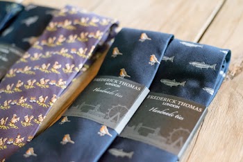 Photo of a Line of Neckties on Wooden Surface