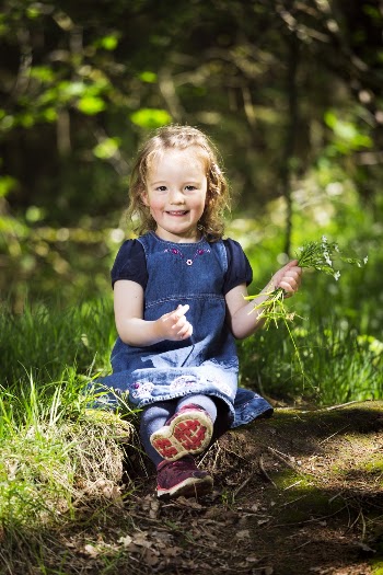 Photo of a Little Girl Sitting on Grass