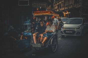 Photo of a Man and Woman Riding Carriage