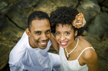 Photo of a Man and Woman Smiling While Standing on Rocks