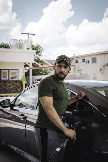 Photo of a  Man Fueling Up His Car