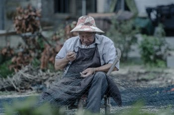 Photo of a Man Holding a Fishing Net