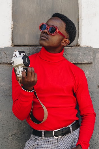 Photo of a Man Holding a Nikon Camera