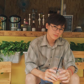 Photo of a Man in Beige Button-up Collared Top Holding Beverage Drink