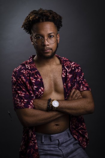 Photo of a Man in Sunglasses and Purple Floral   Unbuttoned Shirt 