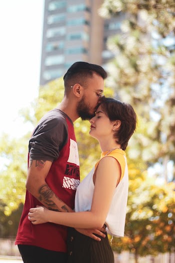 Photo of a Man Kissing Woman on Forehead