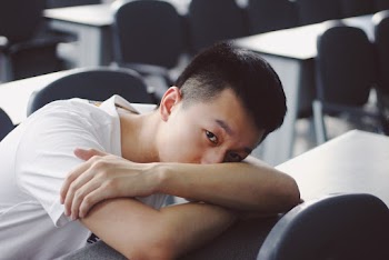 Photo Of A Man Leaning On A Table