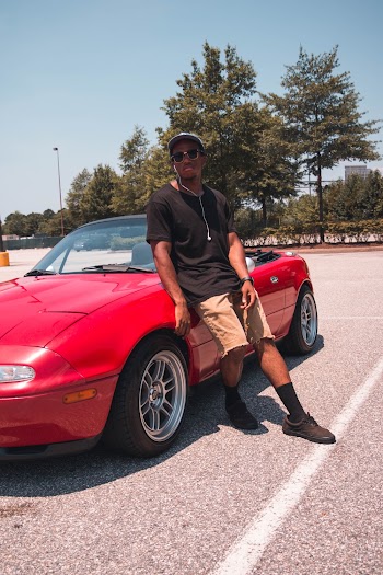 Photo of a Man Leaning on Convertible Coupe