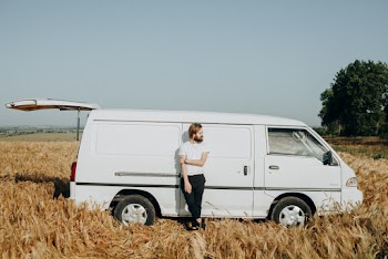 Photo of a Man Leaning on White Van