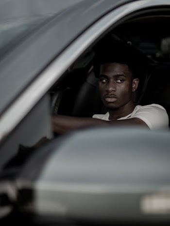 Photo of a Man Looking Through a Car Window