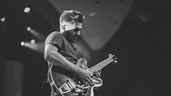 Photo of a Man Playing Electric Guitar
