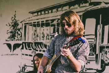Photo of a Man Playing Guitar