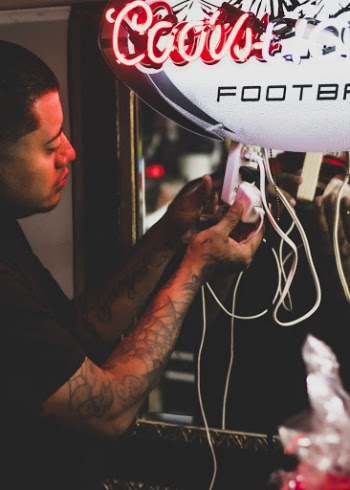 Photo of a Man Plugging in a White Charger into Extension Cord