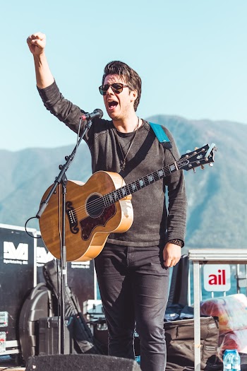 Photo of a Man Singing on Stage