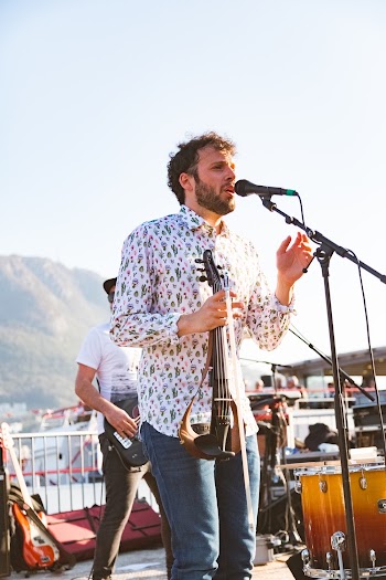 Photo of a Man Singing on Stage