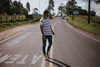 Photo of a Man Standing at Road