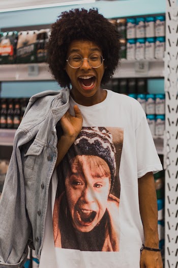 Photo of a man standing in a supermarket with mouth open