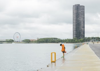 Photo of a Man Standing in Front of Body of Water