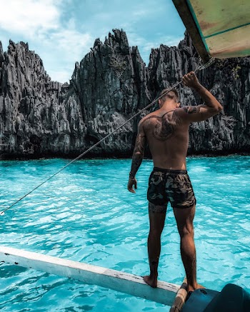 Photo Of A Man Standing On A Boat