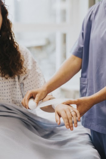 Photo of a Person Bandaging 