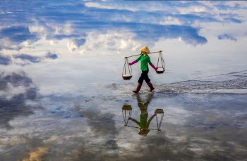 Photo of a Person Carrying Baskets